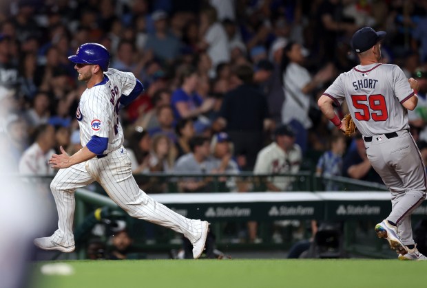 Chicago Cubs first baseman Michael Busch rounds the bases after a single by teammate Miguel Amaya in the sixth inning of a game against the Atlanta Braves at Wrigley Field in Chicago on May 21, 2024. (Chris Sweda/Chicago Tribune)