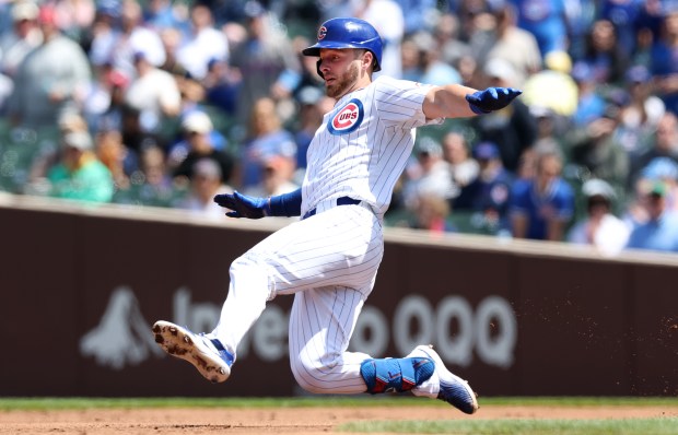 Cubs first baseman Michael Busch slides safely into second base with a double in the second inning against the Brewers on Friday, May 3, 2024, at Wrigley Field. (Chris Sweda/Chicago Tribune)