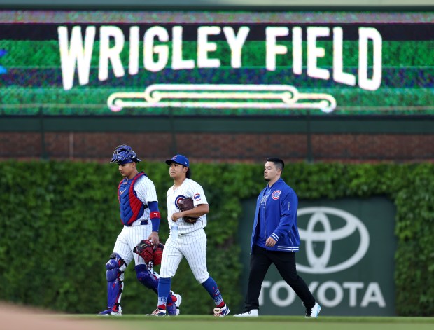 Cubs catcher Miguel Amaya and pitcher Shota Imanaga walk in from the bullpen before Imanaga's start against the Padres at Wrigley Field on May 7, 2024. (Chris Sweda/Chicago Tribune)