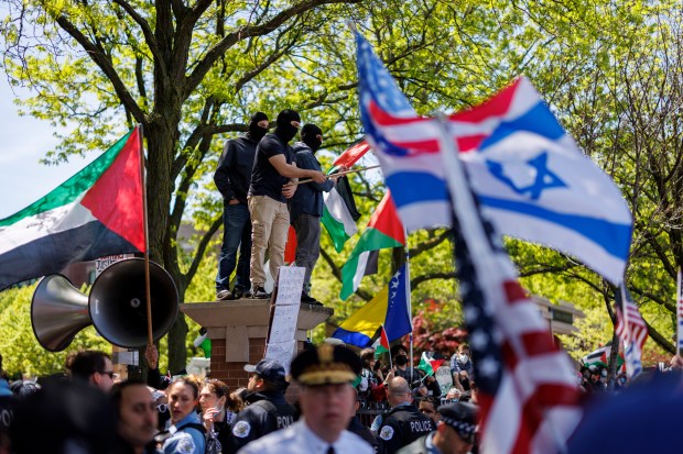 Pro-Palestinian activists argue with pro-Israel activists while members of the Chicago Police department stand between the two groups outside a pro-Palestinian encampment at DePaul University on May 5, 2024, in Chicago. (Armando L. Sanchez/Chicago Tribune)