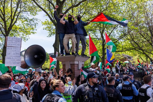 Pro-Palestinian activists argue with pro-Israel activists while members of the Chicago Police Department stand between the two groups outside a pro-Palestinian encampment at DePaul University on May 5, 2024, in Chicago. (Armando L. Sanchez/Chicago Tribune)