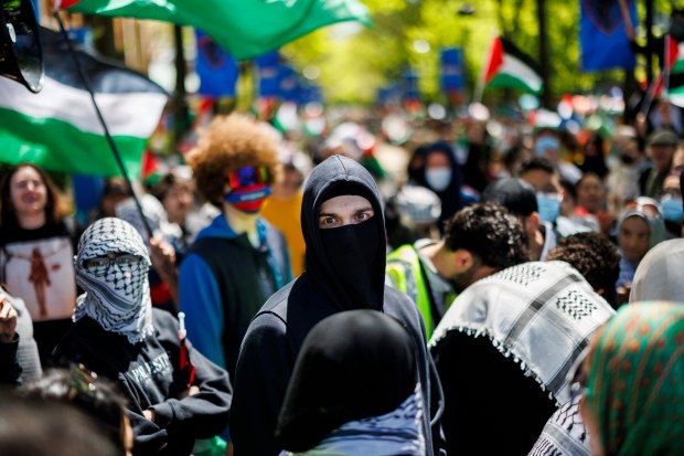 Pro-Palestinian activists argue with pro-Israel activists while members of the Chicago Police department stand between the two groups outside a pro-Palestinian encampment at DePaul University on May 5, 2024, in Chicago. (Armando L. Sanchez/Chicago Tribune)