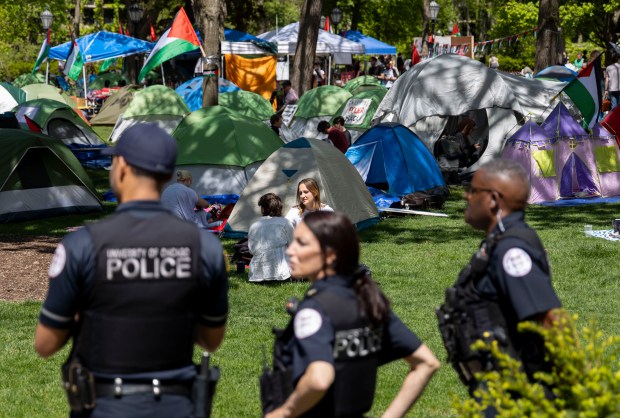 University of Chicago police watch from a short distance as students and community members gather at an encampment on campus on May 1, 2024, in support of Gaza and the Palestinian people. (Brian Cassella/Chicago Tribune)