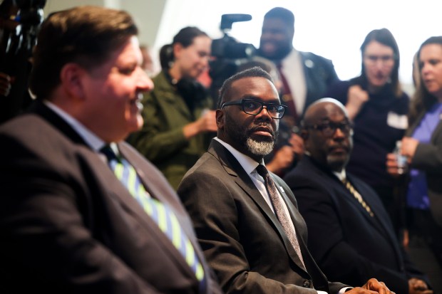 Mayor Brandon Johnson and Gov. J.B. Pritzker, left, before a press conference unveiling a new exhibit for the Archaeopteryx fossil at the Field Museum on May 6, 2024. (Eileen T. Meslar/Chicago Tribune)