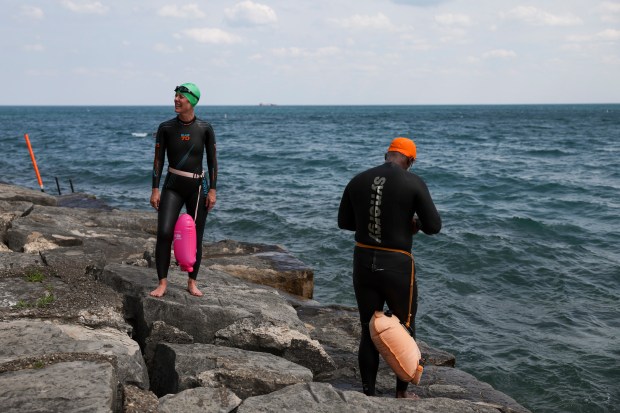 Suzanne Fighera, left, and Howard Logan prepare to swim a mile in Lake Michigan at Promontory Point on May 21, 2024. (Eileen T. Meslar/Chicago Tribune)