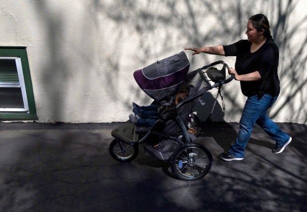 Christina Gonzalez takes her infant twins to a nearby park on April 30, 2024, in Des Plaines. (Stacey Wescott/Chicago Tribune)