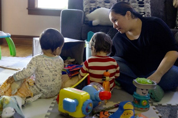 Christina Gonzalez plays with her twins at her home on April 30, 2024, in Des Plaines. (Stacey Wescott/Chicago Tribune)