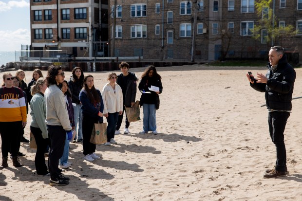 Loyola University Professor Tim Hoellein speaks to students after they collected trash on April 20, 2024, at Hartigan Beach in Chicago. The students earned extra credit in Hoellein's ecology class for their participation in the cleanup. (Vincent Alban/Chicago Tribune)