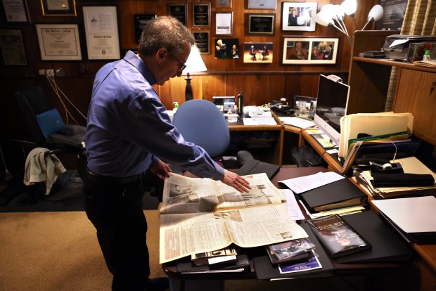 Former Chicago Tribune critic Howard Reich shows copies of the 2001-2002 Tribune series about a Vietnam War vet named Gerald McDonald who learned he was heir to an art fortune looted by the Nazis, May 2, 2024. (Chris Sweda/Chicago Tribune)