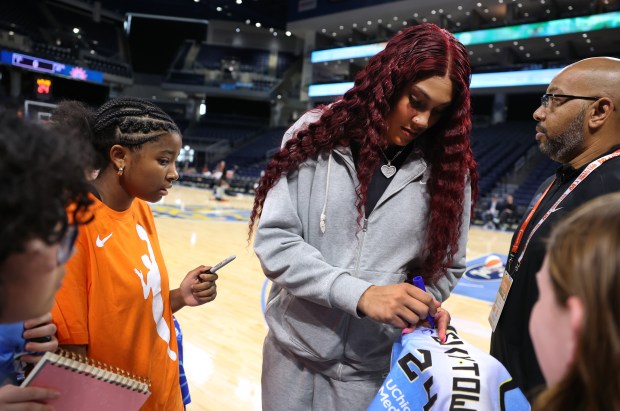 Injured center Kamilla Cardoso signs autographs for young fans before the Sky's home opener against the Connecticut Sun at Wintrust Arena in Chicago on May 25, 2024. (Chris Sweda/Chicago Tribune)