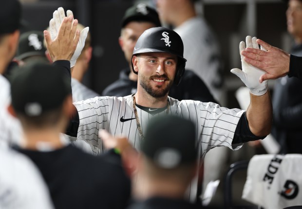White Sox shortstop Paul DeJong is congratulated in the dugout after hitting a solo home run in the seventh inning against the Guardians on May 10, 2024, at Guaranteed Rate Field. (Chris Sweda/Chicago Tribune)