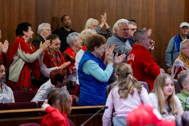 People in favor of the landmark cheer after Ald. Byron Sigcho-Lopez, 25th, spoke during a hearing of the Chicago Landmarks Commission to vote on whether to give landmark status to the St. Adalbert Church building in Pilsen on Friday, May 10, 2024, at City Hall in Chicago. (Vincent Alban/Chicago Tribune)