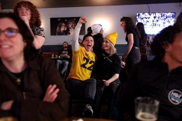 Iowa fans Dani Pillman, left, and Hannah Ludwig cheer as Iowa plays UConn during the women's NCAA Tournament Final Four game being televised at Whiskey Girl Tavern in Chicago's Edgewater neighborhood on April 5, 2024. (Chris Sweda/Chicago Tribune)