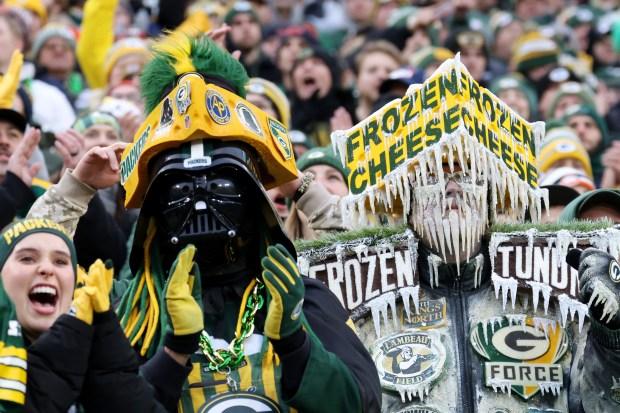 Packers fans dressed as Darth Vader and an icicle celebrate a first down against the Bears in the first quarter at Lambeau Field on Jan. 7, 2024, in Green Bay. (John J. Kim/Chicago Tribune)