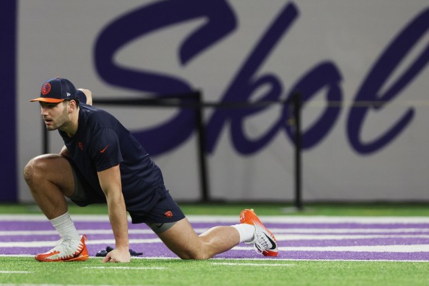 Bears tight end Cole Kmet stretches during pregame warmups on Nov. 27, 2023, at U.S. Bank Stadium in Minneapolis. (Stacey Wescott/Chicago Tribune)