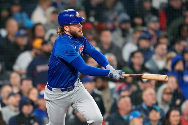 Cubs' Patrick Wisdom follows through on a two-run double during the seventh inning against the Red Sox on April 26, 2024, in Boston. (AP Photo/Michael Dwyer)