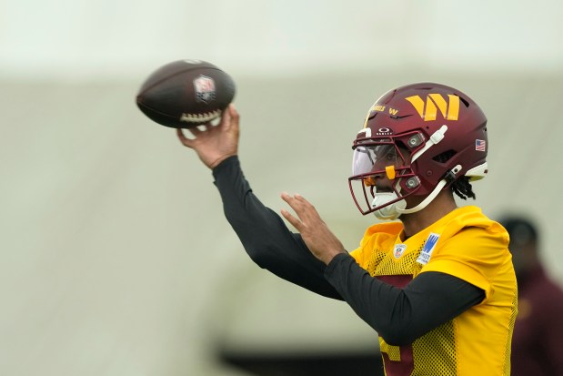 Washington Commanders first round draft pick quarterback Jayden Daniels (5) throws the ball during an NFL rookie minicamp football practice in Ashburn, Va., Friday, May 10, 2024. (AP Photo/Susan Walsh)