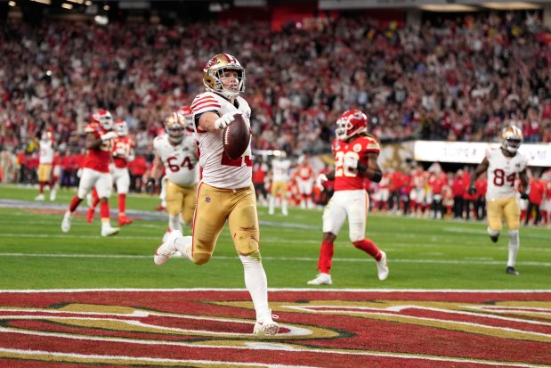 San Francisco 49ers running back Christian McCaffrey (23) run in a touchdownduring the first half of the NFL Super Bowl 58 football game Sunday, Feb. 11, 2024, in Las Vegas. (AP Photo/Doug Benc)