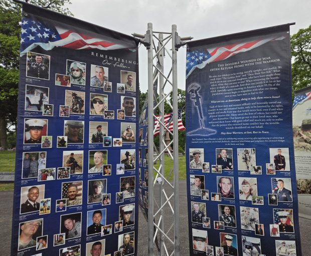 One section of the traveling Remembering Our Fallen photo exhibit set up at Elgin's Bluff City Cemetery is dedicated to those who took their own lives after serving in the military in the years after 9/11. (Gloria Casas/The Courier-News)