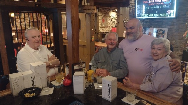 Charles Miller, of Elgin, from left, joins Bill Richard, also of Elgin, Karas Restaurant Group owner Bob Karas and Richard's wife Gwen at the The Village Squire in West Dundee. The restaurant is celebrating its 50th anniversary this year. (Mike Danahey/The Courier-News)