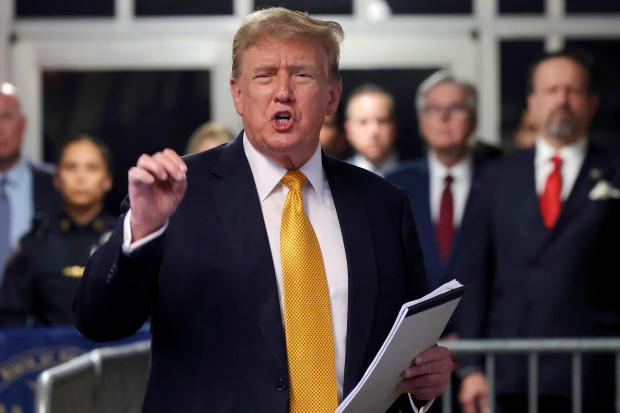 FILE - Former President Donald Trump speaks to reporters at Manhattan Criminal Court, May 21, 2024 in New York. Trump has spent the majority of his time as a criminal defendant sitting nearly motionless for hours, leaning back in his chair with his eyes closed. It is in part a strategy in response to warnings that behaving like he has in past trials could backfire. Trump has also been able to speak several times a day to a gaggle of media camped outside the courtroom, giving him an outlet to vent his frustrations. (Michael M. Santiago/Pool Photo via AP, File)