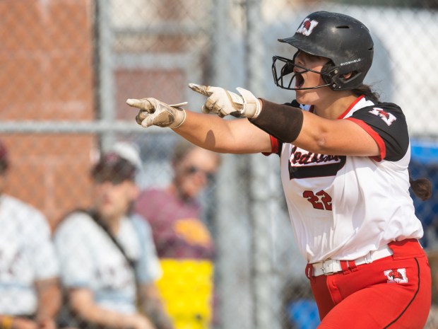 Marist's Gabi Novickas points to her teammates at home plate after hitting a solo hom run against Lockport during the Class 4A Marist Supersectional in Chicago on Monday, June 5, 2023.