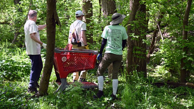 What to do with this Target shopping cart found along the river. The Highland Park Target parking lot is a short distance away so the three volunteers have decided to return it to the store. Finders but not keepers of the misplaced shopping cart are volunteers from left to right, Neal Davies of Highland Park, Brian Frankl of Highland Park and Melanie O'Brien of Rogers Park at the 32nd annual Chicago River Day cleanup location in Highland Park at The Preserve at Highland Park on May 11, 2024. (Karie Angell Luc/Lake County News-Sun)