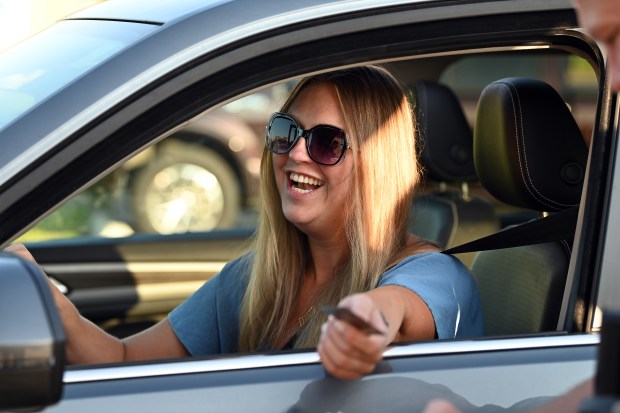 Sharon Pruski of Volo makes a donation at the drive-thru at 280 S. US Highway 12 in Volo at Cop on a Rooftop on May 17, 2024 at Dunkin' in Volo. (Karie Angell Luc/Lake County News-Sun)