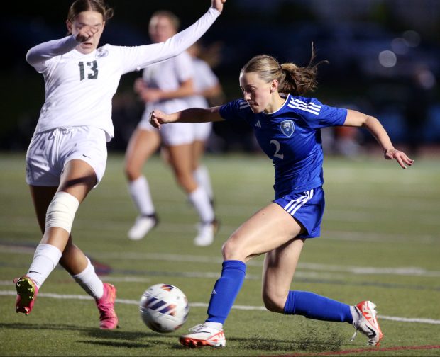 Vernon Hills' Sophie Ackerman (2), getting her shot off before Grayslake Central's Peyton Hoffman (13) arrives, during the Class 2A Vernon Hills Regional semifinal, on Tuesday, May 14, 2024. (Mark Ukena for the Lake County News-Sun)