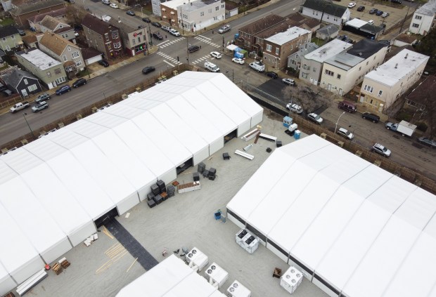 Large tents emerge at a proposed migrant encampment in the Brighton Park neighborhood on Dec. 5, 2023. (Trent Sprague/Chicago Tribune)