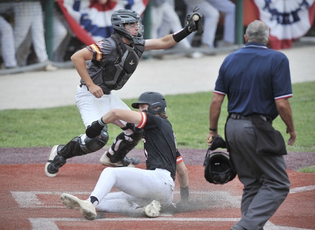 Lincoln-Way West's Cole Crafton scores a run as Lockport catcher Matt Merk catches the ball during the Class 4A Lockport Sectional championship game on Saturday, June 4, 2022.