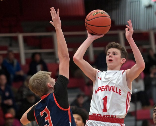 Naperville Central's TJ Hillman shoots a running jump shot over Oswego's Nolan Petry. Naperville Central defeated Oswego, 51-43, in the Class 4A Downers Grove North Regional quarterfinal boys basketball game Monday, Feb. 19, 2024, in Naperville, Illinois. (Jon Langham/photo for Naperville Sun)