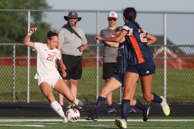 Naperville Central's Emerson Burke (20) makes a pass during the Class 3A Plainfield North Sectional semifinal game against Naperville North in Plainfield on Wednesday, May 22, 2024. (Troy Stolt/for the Naperville Sun)