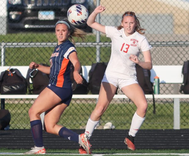 Naperville Central's Emma Russell (13) crosses the ball during the Class 3A Plainfield North Sectional semifinal game against Naperville North in Plainfield on Wednesday, May 22, 2024. (Troy Stolt/for the Naperville Sun)