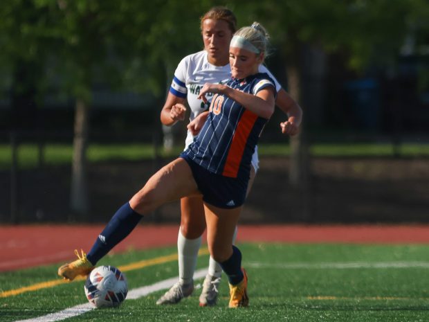 Naperville North's Audrey Hartmann (10) wins possession of the ball from Waubonsie Valley's Eleanor Otter (23) during the Class 3A East Aurora Regional championship game in Aurora on Friday May 17, 2024. (Troy Stolt/for the Naperville Sun)