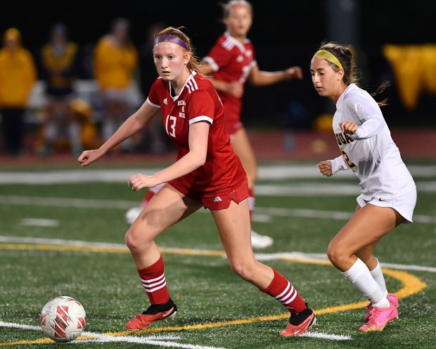 Naperville Central's Emma Russell (13) moves for the ball ahead of Neuqua Valley's Mollie McBrayer during their Class 3A Naperville Central Regional semifinal game Tuesday, May 14, 2024, in Naperville.(Jon Cunningham/for The Naperville Sun)