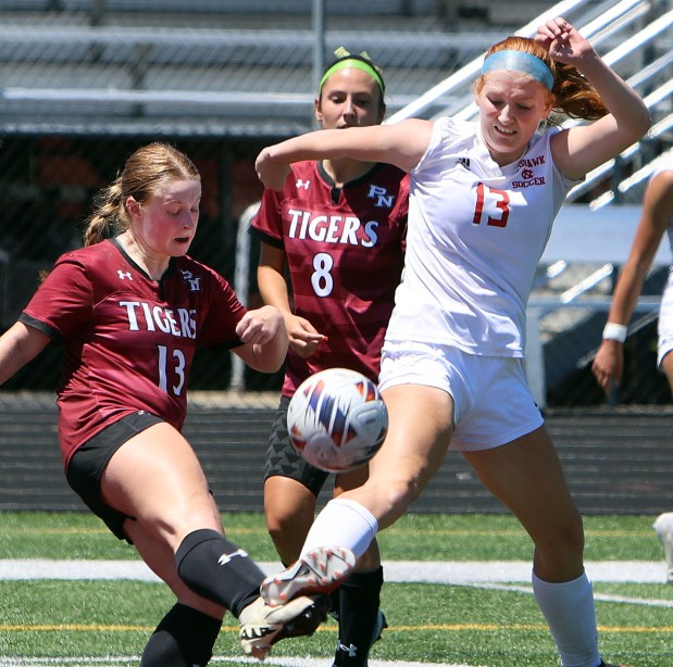 Plainfield North's Mackenzie Harriman, left, and Naperville Central's Emma Russell, right, battle for the ball during the Class 3A Plainfield North sectional championship soccer game Saturday, May 25, 2024, in Plainfield.  (James C. Svehla/for the Naperville Sun)