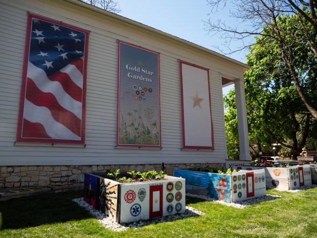 Raised garden beds sit outside the Daniels House on Naper Settlement's museum campus on Tuesday, April 30, as part of a living memorial created by Naperville nonprofit OLI Gardens in honor of local military members that died in active service, as well as first responders that were killed in the line of duty. (Tess Kenny/Naperville Sun)