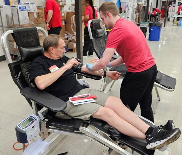Dale Chobak, of Bolingbrook, has his blood drawn Saturday morning during the A Pint for Kim blood drive at Naperville North High School. He said he and his wife, Maureen, have given blood all five years that the event's been held. (David Sharos/Naperville Sun)