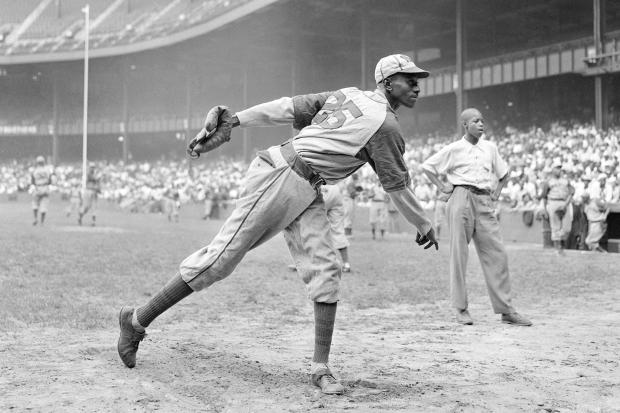 Kansas City Monarchs pitcher Leroy Satchel Paige warms up at New York's Yankee Stadium before a Negro League game between the Monarchs and the New York Cuban Stars in August 1942. (Matty Zimmerman/AP)