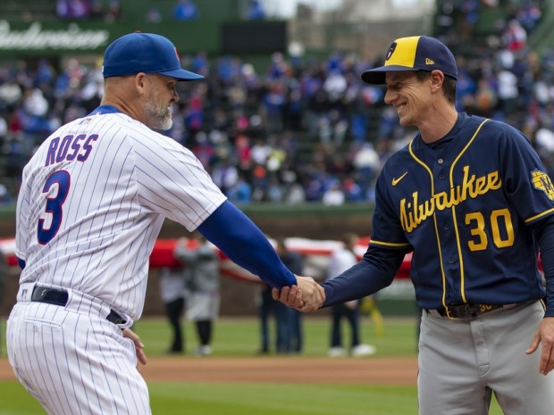 Chicago Cubs manager David Ross meets Milwaukee Brewers manager Craig Counsell at home plate on Opening Day, April 7, 2022, at Wrigley Field.