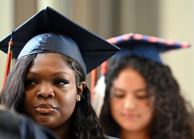 From left, Sheniah Tara Cunningham and Miigus Niibin Curley wait to enter the arena for Evanston Township High School's commencement at Northwestern University's Welsh-Ryan Arena at McGaw Memorial Hall in Evanston on May 19, 2024. (Karie Angell Luc/Pioneer Press)