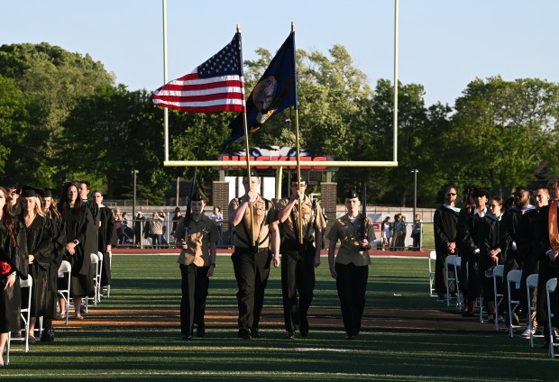 The NJROTC presents the colors. From left to right are Ava McQuade of Arlington Heights, Aiden Ritchie of Mount Prospect, Dale Costello of Arlington Heights and Annalise Johnson of Arlington Heights at graduation on May 22, 2024 at John Hersey High School at Roland R. Goins Stadium. (Karie Angell Luc/Pioneer Press)