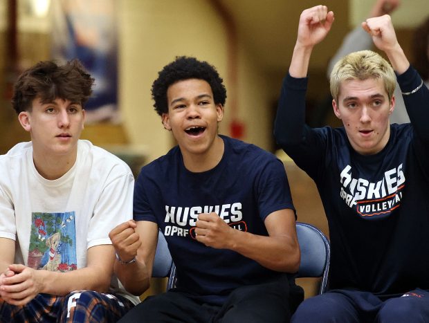 Sidelined with an injury Oak Park-River Forest's Trayce Chrusfield III (second from right) reacts to a point with teammates during a West Suburban Conference match against Proviso East on Thursday, April, 25, 2024 in Oak Park. H. Rick Bamman / For Pioneer Press