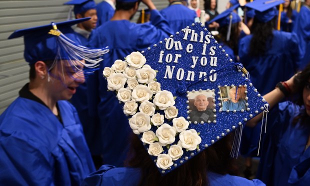 For their late grandfather Giuseppe. Wearing the mortarboard dedicated to her late grandfather Giuseppe, Marianna Pelagio, 18, of Niles graduated with her twin Rocco,at left, at Maine East High School's graduation in Rosemont on May 19, 2024 at the Rosemont Theatre. (Karie Angell Luc/Pioneer Press)