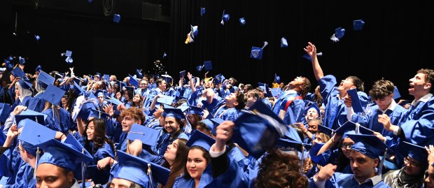 A delayed cap toss on stage at Maine East High School's graduation in Rosemont on May 19, 2024 at the Rosemont Theatre (5400 N. River Road). (Karie Angell Luc/Pioneer Press)