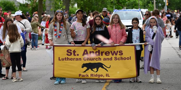 Candy flies in front of the banner at the Park Ridge Memorial Day Parade on May 27, 2024 in Park Ridge. (Karie Angell Luc/Pioneer Press)