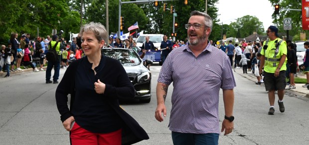 From left, Lauren and Marty Maloney of Park Ridge walk the route on Cumberland Avenue. Marty Maloney is the mayor of Park Ridge. Taken at the Park Ridge Memorial Day Parade on May 27, 2024 in Park Ridge. (Karie Angell Luc/Pioneer Press)