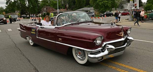 A 1956 Cadillac Eldorado Biarritz convertible. From left, Marie Sartor Pawelek, 100, of Park Ridge, as parade grand marshal, waves to the crowd on Cumberland Avenue at the Park Ridge Memorial Day Parade on May 27, 2024 in Park Ridge. (Karie Angell Luc/Pioneer Press)