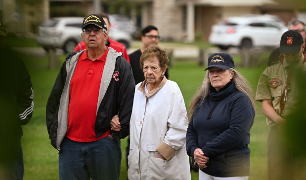 From left to right, attending a commemoration of the Veterans Monument along the South Park fieldhouse in Park Ridge before the Park Ridge Memorial Day Parade are Michael Pawelek of Elmhurst, Michael's mother Marie Sartor Pawelek, 100, of Park Ridge and parade grand marshal and Joan Mattingly of Park Ridge on May 27, 2024 in Park Ridge. (Karie Angell Luc/Pioneer Press)